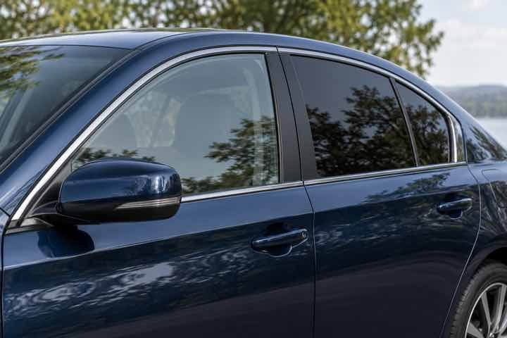 Dark blue sedan showing a lighter front side window and a darker rear side window